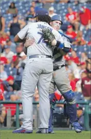  ?? Hunter Martin Getty Images ?? KENLEY JANSEN gets a hug from catcher Yasmani Grandal after finishing up his 39th save of season.