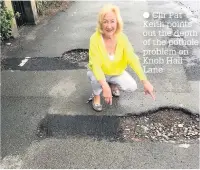  ??  ?? Cllr Pat Keith points out the depth of the pothole problem on Knob Hall Lane