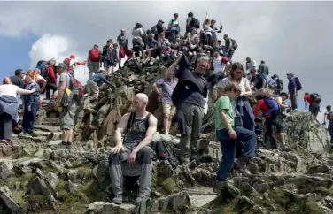  ??  ?? [left] Typical sunny day foot traffic on Snowdon's Pyg / Miner's Track [above] The summit of Snowdon on a May Bank Holiday; many organisati­ons are worried about a 'mad rush' to outdoor honeypots