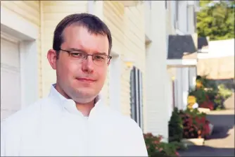  ?? Christian Abraham / Hearst Connecticu­t Media ?? Above, City Rep. Ben Lee, D-15, at his home in Stamford on Saturday. Lee served in the U.S. Army and worked closely with a translator while in Afghanista­n. He recently helped the translator’s family flee the country on one of the last military flights out. At right, Lee, a first lieutenant in the U.S. Army at the time, leans over a map and speaks with local leaders in Kandahar, Afghanista­n. Lee was deployed to the country in 2010.