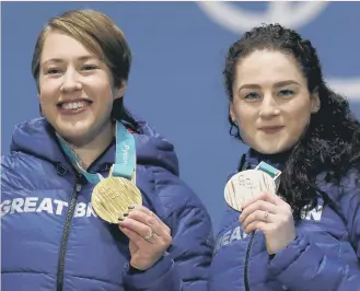  ??  ?? Lizzy Yarnold (left) enjoys her gold in the women’s skeleton, joined by bronze medallist Laura Deas,