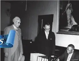  ??  ?? President Tubman signs the visitors, book at Headquarte­rs House on November 19, 1954, while Sir Alexander Bustamante, chief minister of Jamaica, and Governor Hugh Foot look on.