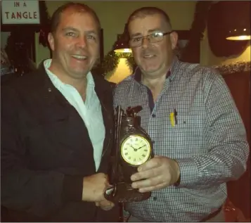  ??  ?? Noel Kendrick receiving his golfer of the year trophy from Taghmon Society Captain Eamon Roche (right).