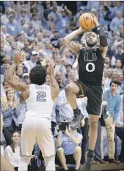  ?? Gerry Broome Associated Press ?? JA’QUAN NEWTON of Miami hits a 30-footer over North Carolina’s Joel Berry II, who’d just hit a three.