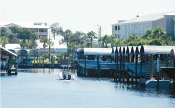  ?? JAY REEVES/AP PHOTOS ?? A boat cruises at a marina Tuesday in Mexico Beach, Fla., which was nearly wiped out by a storm in 2018.