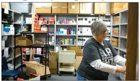  ?? NWA Democrat-Gazette/CHARLIE KAIJO ?? Counselor Brenda Walkenbach opens the door to a food pantry on Friday at New Technology High School in Rogers.