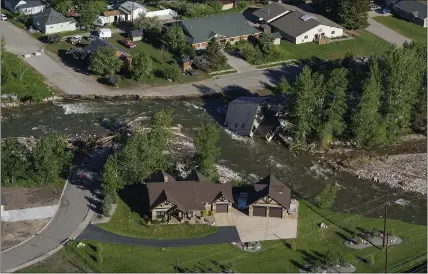  ?? DAVID GOLDMAN — THE ASSOCIATED PRESS ?? The entrance to Yellowston­e National Park, a major tourist attraction, is closed due to the historic floodwater­s last week that almost swept away a home in Gardiner, Mont. The park is facing its biggest challenge in decades.