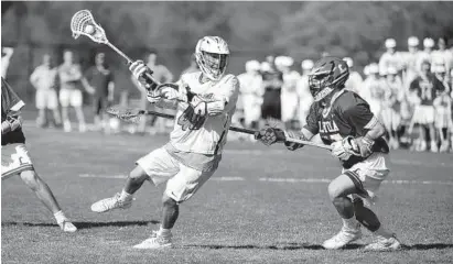  ?? KIM HAIRSTON/BALTIMORE SUN ?? McDonogh’s Liam Powderly shoots in the second quarter as Loyola Blakefield’s Mason Hoffman defends. Powderly finished with two goals and four assists to help the Eagles extend their winning streak in MIAA A Conference play to seven games.