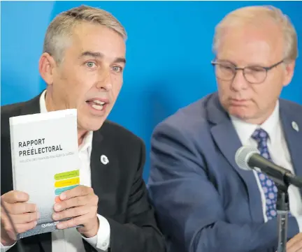  ?? PETER McCABE/THE CANADIAN PRESS ?? “We don’t want a budget that will hurt people,” Parti Québécois Leader Jean-François Lisée said Thursday as he and candidate Nicolas Marceau, left, unveiled the party’s financial plan. Lisée said the “jackpot” is over for Quebec’s doctors.