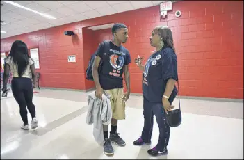  ?? HYOSUB SHIN / HSHIN@AJC.COM ?? Deborah Sumlin talks to her son Torre Sumlin, 17, before football practice at Therrell High School. Finding out Torre has autism has made all the difference, she says. “He feels like, ‘It’s OK, I’m not the only one.’”