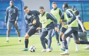  ??  ?? Giroud (left) vies with France’s forward Nabil Fekir (centre) during a training session at the Glebovets Stadium in Istra, some 70 km west of Moscow ahead of the Russia 2018 World Cup football tournament. — AFP photo