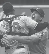  ?? TED S. WARREN/AP ?? Orioles pitcher John Means hugs catcher Pedro Severino after Means threw a no-hitter against the Mariners on Wednesday in Seattle.