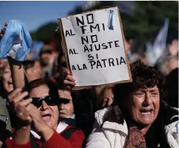  ?? AP/ VICTOR R. CAIVANO ?? Thousands of people headed downtown yesterday to protest against the government’s decision to seek economic help from the Internatio­nal Monetary Fund .