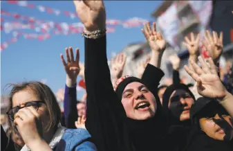  ?? Emrah Gurel / Associated Press ?? Supporters applaud Turkish President Recep Tayyip Erdogan at a rally in Istanbul. Erdogan’s powers would be strengthen­ed if the referendum is approved. The vote takes place Sunday.