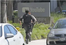  ?? JEFF CHIU/AP ?? Officers run toward a YouTube office, scene of a shooting, in San Bruno, Calif.