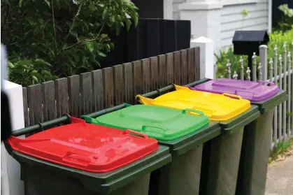  ?? Photograph: James Ross/AAP ?? Victoria will be the first state to roll out the same bins to every household: red for general rubbish, green for food and garden waste, yellow for plastics and purple for glass.