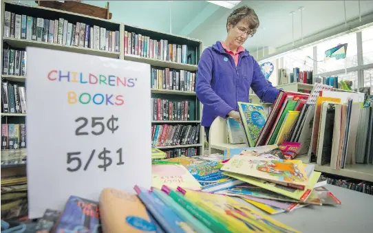  ?? PHOTOS: PETER MCCABE ?? Ute Wilkinson, a librarian at the Lester B. Pearson School Board, also is part of a network of volunteers finding homes for books. “Opening those boxes of books left over from the sale each month is like Christmas,” she says. “I never know what...