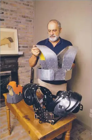  ?? Bruce Bennett
Houston Chronicle ?? AN INNOVATOR Byron Donzis, who invented a flak jacket for football players, displays shoulder pads made from
aircraft aluminum in 1985. Donzis also created an X-ray machine for checking leaky oil pipes.