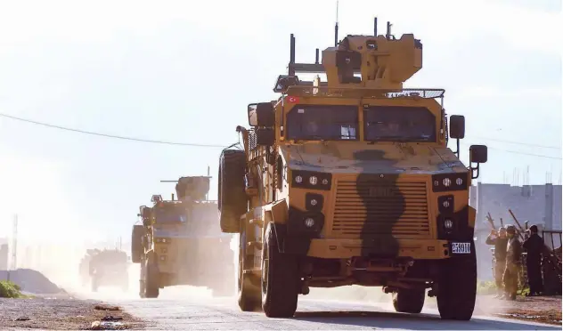  ?? Agence France-presse ?? ↑ A convoy of armoured Turkish military vehicles drives along a road in Khan Sheikhun on Sunday.