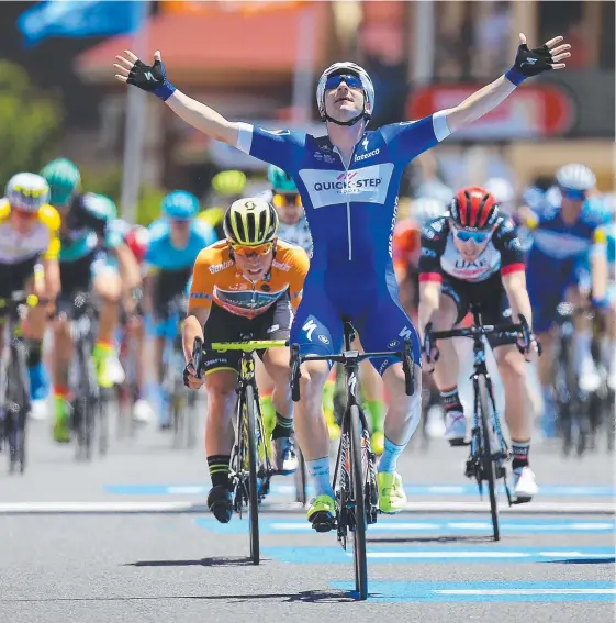  ?? Picture: GETTY IMAGES ?? Italian Elia Viviani crosses the finish line ahead of Caleb Ewan (orange top) yesterday as the riders entered Victor Harbor.