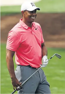  ??  ?? A relaxed Tiger Woods during a practice round yesterday.