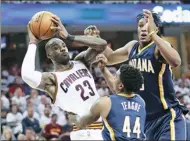 ?? TONY DEJAK / AP ?? Cleveland Cavaliers’ LeBron James eyes a pass as Indiana Pacers’ Myles Turner and Jeff Teague swarm during Game 1 of the first-round NBA playoff series on Saturday in Cleveland. The Cavs prevailed 109-108.