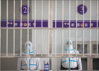  ?? Mark Schiefelbe­in / Associated Press ?? Security officers guard a reception area at Urumqi No. 3 Detention Center in Dabancheng in western China’s Xinjiang region. The detention center has room for at least 10,000 inmates.