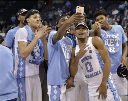  ?? BRANDON DILL — THE ASSOCIATED PRESS ?? North Carolina players celebrate after beating Kentucky in the South Regional final in the NCAA Tournament on March 26.