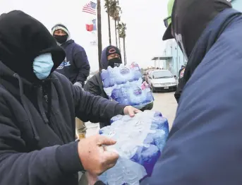  ?? Elizabeth Conley / Staff photograph­er ?? Mayor Sylvester Turner, front left, and Police Chief Art Acevedo, second from left, talk to a woman as they tour a city warming shelter Wednesday at the George R. Brown Convention Center.