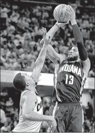  ?? AP/TONY DEJAK ?? Indiana forward Paul George (13) shoots over Cleveland’s J.R. Smith in the second half of the Cavaliers’ 109-108 victory in the first game of their NBA Eastern Conference series against the Pacers. George had a team-high 29 points for the Pacers.