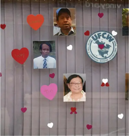  ??  ?? Photograph­s of the six JBS plant workers who died of COVID-19 hang in the window of the UFCW Local 7 union office on June 28 in Greeley.