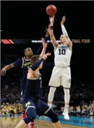  ?? DAVID J. PHILLIP — THE ASSOCIATED PRESS FILE ?? Villanova’s Donte DiVincenzo takes a shot against Michigan during the NCAA final in April. The underclass­men is a likely first-round pick in Thursday’s NBA draft.