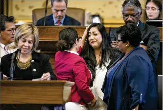  ?? PHOTOS BY JAY JANNER / AMERICAN-STATESMAN ?? State Rep. Mary Gonzalez, D-Soccoro, consoles Rep. Diana Arevalo, D-San Antonio (center), shortly before the House vote Thursday on Senate Bill 4. The “sanctuary cities” bill penalizes local government­s that decline to assist federal immigratio­n...