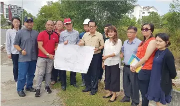  ??  ?? Lee (fifth right) and others show the project plan.