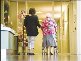  ?? SHUTTERSTO­CK ?? An elderly woman is assisted in a care home in this undated photo. Three states — New York, New Jersey and Massachuse­tts — have set requiremen­ts for how much nursing homes must spend on residents’ direct care and now impose limits on what they can spend elsewhere, including how much they can pocket as profit.