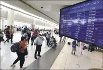  ?? WILL LESTER — STAFF PHOTOGRAPH­ER ?? Travelers wait to pick up their luggage at baggage claim inside Terminal 4at Ontario Internatio­nal Airport on Wednesday. Air travel has returned to near pre-pandemic levels.