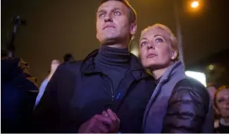  ?? ?? FILE - Russian opposition leader Alexei Navalny, left, and his wife Yulia after a rally in rain-soaked Moscow, Russia, Sept. 6, 2013.