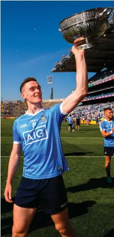  ?? STEPHEN McCARTHY/SPORTSFILE ?? Brian Fenton celebrates with the Delaney Cup after Dublin defeated Laois in front 41,728 spectators at last year’s Leinster final