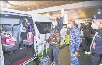  ??  ?? Pandelela poses for the media before heading to a quarantine centre. — Bernama photo