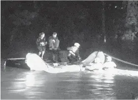  ?? VINCE BARRACCHIN­I/FOR THE BALTIMORE SUN ?? Baltimore County emergency workers rescue a couple after their car was engulfed by floodwater­s on Frederick Road. Up to 2 inches of water had fallen by 8 p.m. Saturday.