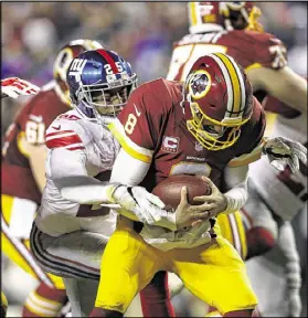  ?? PATRICK SMITH / GETTY IMAGES ?? Defensive back Leon Hall sacks Kirk Cousins in the Giants’ 19-10 victory over the Redskins. The Redskins needed a win to make the playoffs for a second straight season.