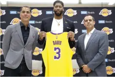  ?? Damian Dovarganes/Associated Press ?? ■ Los Angeles Lakers general manager Rob Pelinka, left, and Head Coach Frank Vogel, right, introduce Anthony Davis on Saturday at a news conference at the UCLA Health Training Center in El Segundo, Calif.,