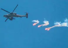  ?? Bloomberg ?? An Israeli military helicopter launches an air strike in Gaza, on Sunday.