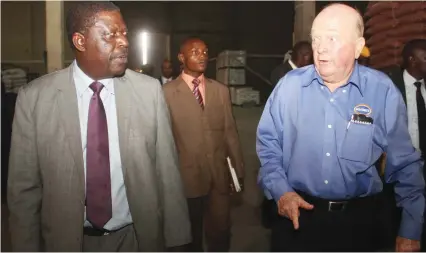  ?? — (Picture by Kudakwashe Hunda) ?? Irvine’s Zimbabwe (Private) Limited chief executive David Irvine (right) explains to Industry and Commerce Minister Mike Bimha the feed production process during a tour of the company’s plant in Harare yesterday.