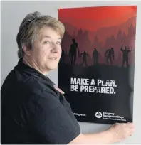  ?? PHOTO: LINDA ROBERTSON ?? Get ready . . . Emergency Management Otago public informatio­n manager Michele Poole shows one of the posters being used to promote a natural disaster preparedne­ss campaign.