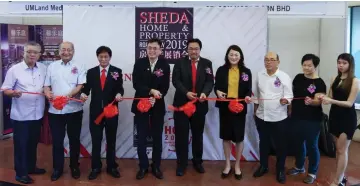  ??  ?? Tan (fourth left) joins Lau (centre), Clarence (left), Joseph (third left) and others in the ribbon-cutting ceremony.