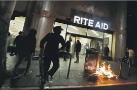  ?? Luis Sinco Los Angeles Times ?? POLICE said organized groups not connected with protesters targeted pharmacies amid unrest because prescripti­on drugs are easily sold on the black market.