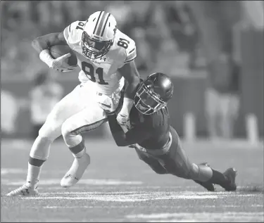  ?? NWA Democrat-Gazette/J.T. WAMPLER ?? Auburn's Darius Slayton (81) drags an Arkansas defender Saturday at Donald W. Reynolds Razorback Stadium in Fayettevil­le.