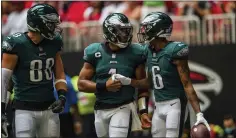  ?? DANNY KARNIK — ASSOCIATED PRESS ?? Eagles wide receiver DeVonta Smith, right, may have had a word or two with quarterbac­k Jalen Hurts, center, after the Eagles were beaten by the Giants 13-7last Sunday.