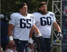  ?? NANCY LANE — BOSTON HERALD ?? James Ferentz, left, and David Andrews head for the field for practice on Aug. 25, 2021 in Foxboro. Ferentz will play center for the injured Andrews on Sunday.